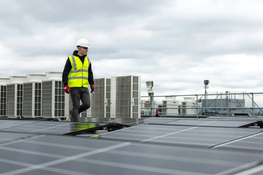 Engineer on a rooftop beside condenser units